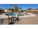 Large pool with a waterfall and a patio with seating for entertaining at 6416 W Parkside Ln, Glendale, AZ 85310