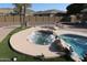 Soothing spa nestled beside the pool, perfect for relaxation after a swim at 6416 W Parkside Ln, Glendale, AZ 85310