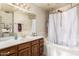 Inviting bathroom features a bathtub with shower and vanity with countertop space at 6422 W Garden Dr, Glendale, AZ 85304