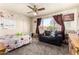 This bedroom features a white metal bed frame, a sofa, a large window and is decorated with unicorn themed decals at 6422 W Garden Dr, Glendale, AZ 85304