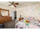 This bedroom features a white metal bed frame and is decorated with various decals and drawings at 6422 W Garden Dr, Glendale, AZ 85304