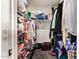 This closet features clothes and shoes hanging in it, other items are stacked on the shelf and on the closet floor at 6422 W Garden Dr, Glendale, AZ 85304