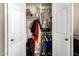 This walk in closet is filled with items on hangers, folded on shelves, and some plastic containers at 6422 W Garden Dr, Glendale, AZ 85304