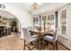 Bright dining area features plantation shutters, tile flooring, and an archway to the living room at 6422 W Garden Dr, Glendale, AZ 85304