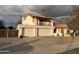 Two-story home with a balcony, three-car garage, and tile roof in a sunny neighborhood at 6422 W Garden Dr, Glendale, AZ 85304