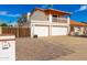 Inviting two-story home features a three-car garage, balcony, and gated driveway for added privacy at 6422 W Garden Dr, Glendale, AZ 85304