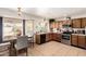 Charming eat-in kitchen with stainless appliances and a bright window over the sink and dining area at 6422 W Garden Dr, Glendale, AZ 85304