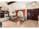 Bright living room featuring a vaulted ceiling, large windows, and stylish decor for comfortable living at 6422 W Garden Dr, Glendale, AZ 85304