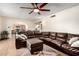 Spacious living room with tile flooring, large sectional sofa, and an archway leading to other rooms at 6422 W Garden Dr, Glendale, AZ 85304