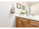 Clean bathroom with wood cabinets and a framed mirror at 6605 N 93Rd N Ave # 1082, Glendale, AZ 85305