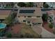 Aerial view of the home showcasing backyard with solar panels and green grass at 7461 W Tumblewood Dr, Peoria, AZ 85382