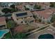 Aerial view of the home showcasing backyard with solar panels, pool and patio at 7461 W Tumblewood Dr, Peoria, AZ 85382