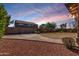 This is a backyard with rock groundcover, a brick paved patio, and a block wall at 7461 W Tumblewood Dr, Peoria, AZ 85382