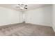 Empty bedroom features neutral carpet, ceiling fan, and 2 entry doors at 7461 W Tumblewood Dr, Peoria, AZ 85382