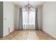 Dining room with tile floors, gray curtains, and chandelier at 7461 W Tumblewood Dr, Peoria, AZ 85382