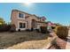 Charming two-story home with a three-car garage and a well-manicured front yard at 7461 W Tumblewood Dr, Peoria, AZ 85382