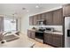 Kitchen featuring tile floors, gray cabinets and stainless steel appliances at 7461 W Tumblewood Dr, Peoria, AZ 85382