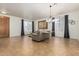 Large living room with tile flooring, neutral paint, gray curtains, and modern furniture at 7461 W Tumblewood Dr, Peoria, AZ 85382