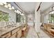 Elegant bathroom with double sinks, soaking tub, and large mirror at 7500 E Boulders Pkwy # 11, Scottsdale, AZ 85266