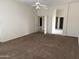 Spacious carpeted bedroom with ceiling fan and access to other rooms at 7668 E Thunderhawk Rd, Scottsdale, AZ 85255