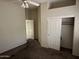 Bright bedroom with ceiling fan and double door closet at 7668 E Thunderhawk Rd, Scottsdale, AZ 85255