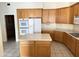 Kitchen with oak cabinets and island at 7668 E Thunderhawk Rd, Scottsdale, AZ 85255