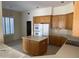 Kitchen with oak cabinets, island, and appliances at 7668 E Thunderhawk Rd, Scottsdale, AZ 85255