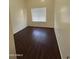 Well-lit bedroom with dark wood flooring and window at 7685 W San Miguel Ave, Glendale, AZ 85303