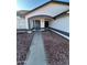 House entrance with walkway and rock landscaping at 7685 W San Miguel Ave, Glendale, AZ 85303