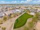 Aerial view showing houses and a green space at 7718 W Raymond St, Phoenix, AZ 85043