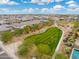 Aerial view of a community with a park and houses at 7718 W Raymond St, Phoenix, AZ 85043