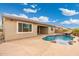 Stunning pool with a spa and a relaxing waterfall feature in the backyard at 7718 W Raymond St, Phoenix, AZ 85043