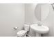 Simple and elegant bathroom with pedestal sink and toilet at 7718 W Raymond St, Phoenix, AZ 85043