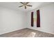 Spacious bedroom with ceiling fan and dark curtains at 7718 W Raymond St, Phoenix, AZ 85043