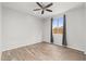 Well-lit bedroom with ceiling fan and window coverings at 7718 W Raymond St, Phoenix, AZ 85043