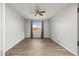 Spacious bedroom with ceiling fan and large window at 7718 W Raymond St, Phoenix, AZ 85043