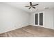 Bright bedroom with double doors and ceiling fan at 7718 W Raymond St, Phoenix, AZ 85043