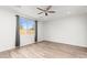 Spacious bedroom with wood-look flooring and ceiling fan at 7718 W Raymond St, Phoenix, AZ 85043