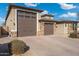 Two-car carriage garage doors lead to a paver driveway at 7718 W Raymond St, Phoenix, AZ 85043