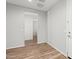 Clean hallway with wood-look flooring leading to bathroom at 7718 W Raymond St, Phoenix, AZ 85043