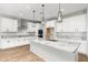 Modern kitchen with white cabinets, granite countertops, and stainless steel appliances at 7718 W Raymond St, Phoenix, AZ 85043