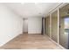 Bright living room with sliding glass doors leading to the backyard at 7718 W Raymond St, Phoenix, AZ 85043