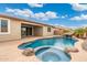 Relaxing pool area with a spa and water feature; perfect for entertaining at 7718 W Raymond St, Phoenix, AZ 85043