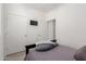 Simple bedroom with mounted TV and double door closet at 7820 E Baseline Rd # 103, Mesa, AZ 85209