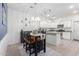 Bright dining room adjacent to kitchen, featuring a wooden table and six chairs at 7820 E Baseline Rd # 103, Mesa, AZ 85209