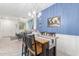 Open concept dining room with a wooden table and chairs, adjacent to the kitchen at 7820 E Baseline Rd # 103, Mesa, AZ 85209