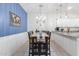 Dining area with a wooden table, six chairs, and a blue accent wall at 7820 E Baseline Rd # 103, Mesa, AZ 85209