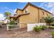 Tan two-story home with a white fence and landscaping at 7820 E Baseline Rd # 103, Mesa, AZ 85209