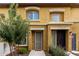 Front view of a tan two-story townhome with a walkway and landscaping at 7820 E Baseline Rd # 103, Mesa, AZ 85209