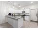 Modern kitchen with white cabinets, granite countertops, and an island at 7820 E Baseline Rd # 103, Mesa, AZ 85209